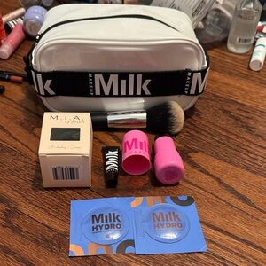 Milk Makeup White and Black Glossy Cosmetic Pouch with Pink Accessories